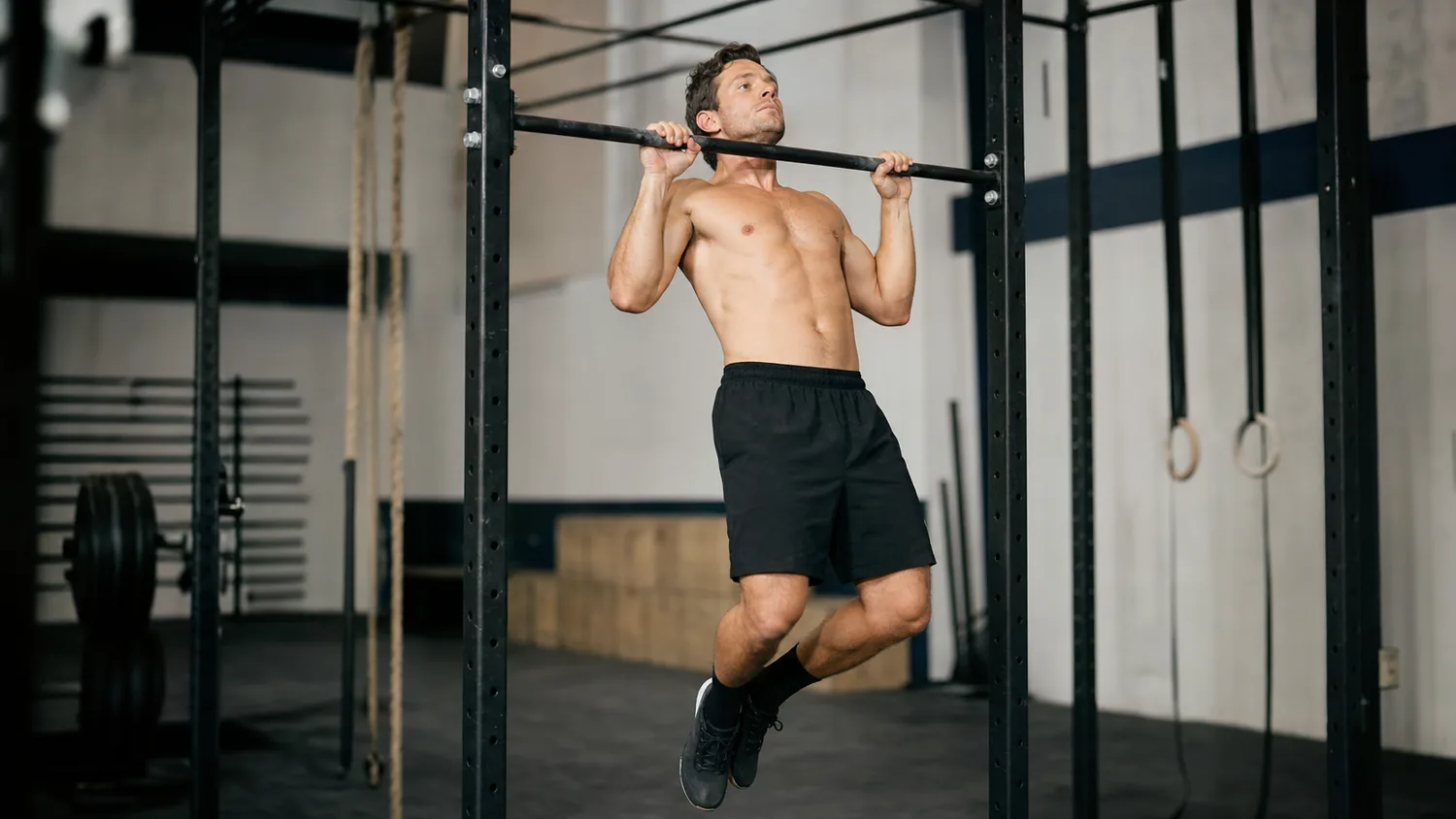 Athlete finishing the pull-up phase of a burpee pull-up