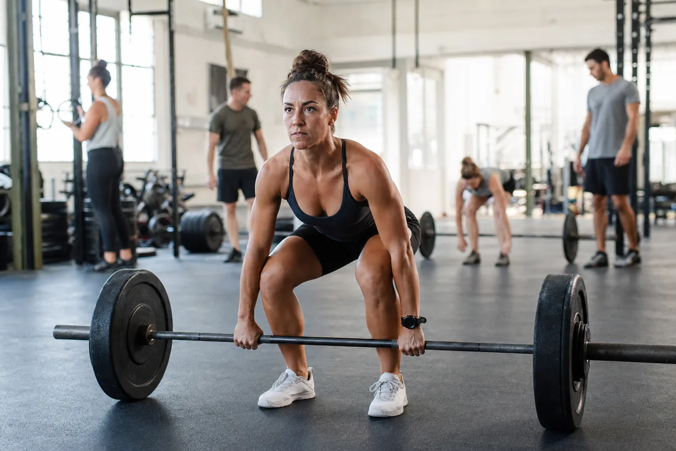 CrossFit athlete resetting a deadlift between workout reps