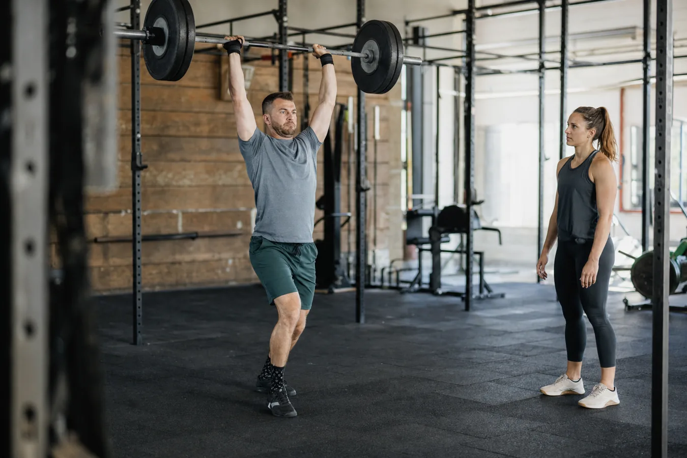 CrossFit athlete using leg drive during a barbell push press