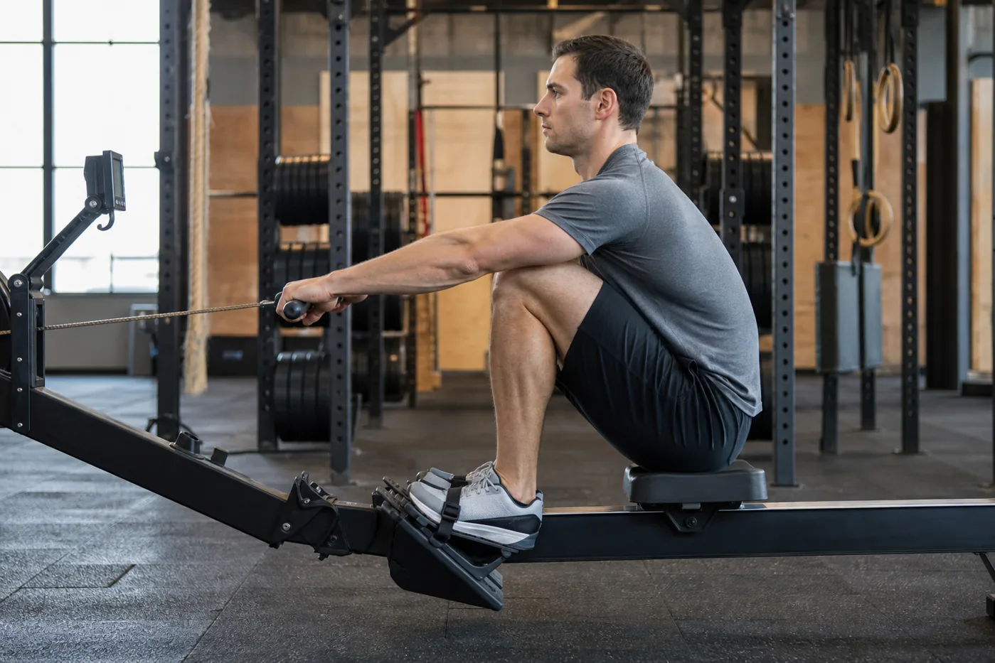 Athlete setting the catch position on an indoor rower