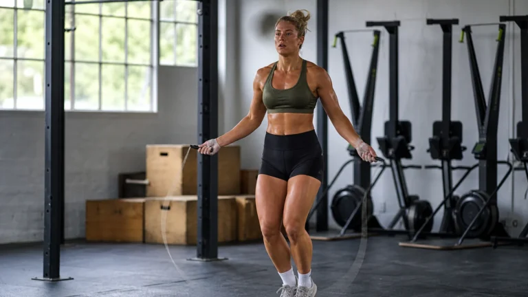 Athlete practicing double unders with a jump rope in a CrossFit gym