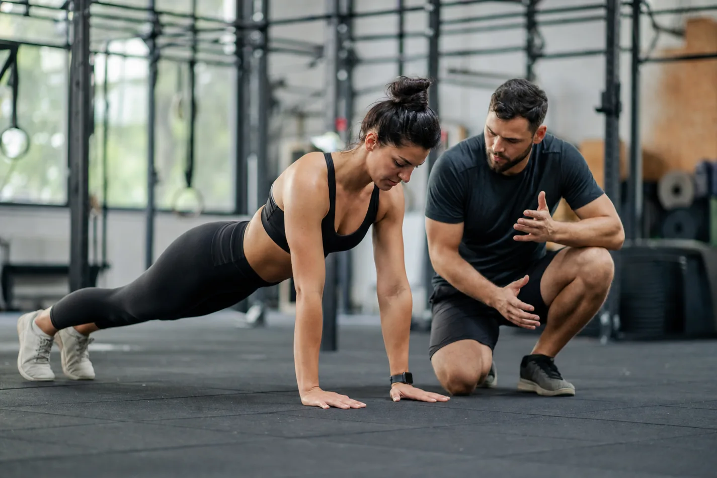 CrossFit athlete finishing a hand release push-up in a strong plank position