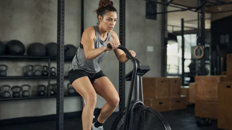 CrossFit athlete riding a BikeErg during a conditioning workout