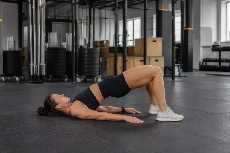 CrossFit athlete performing a glute bridge with hips lifted and feet planted