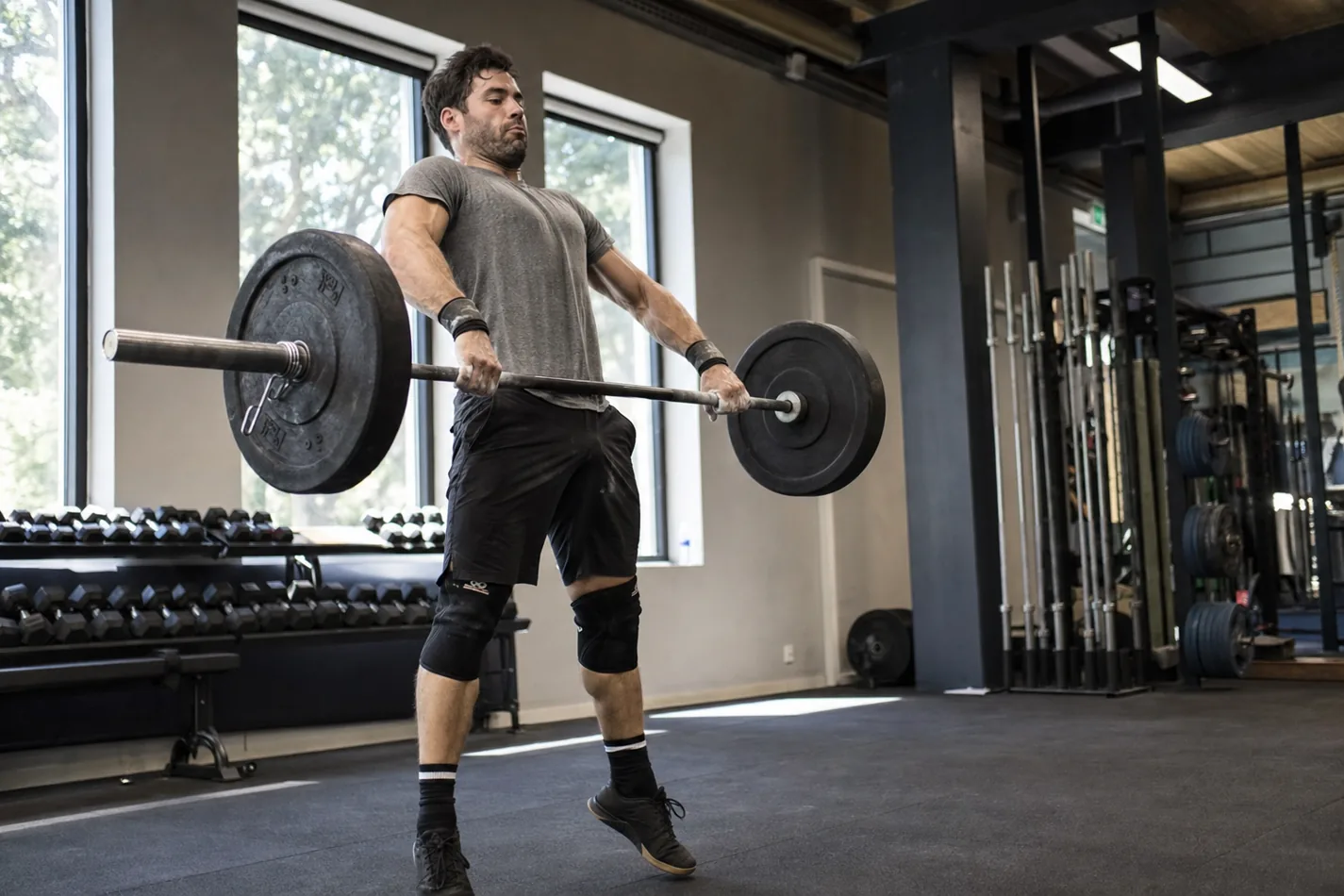 CrossFit athlete performing a hang power clean with a close bar path