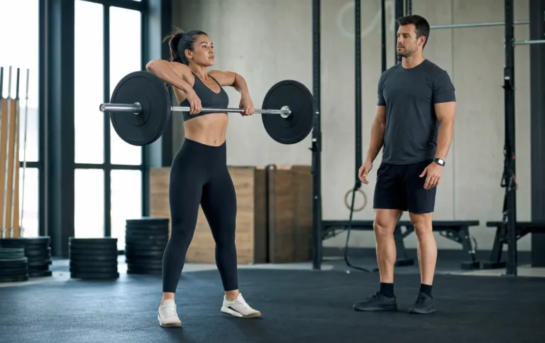 Athlete performing a high hang clean with a barbell in a CrossFit gym