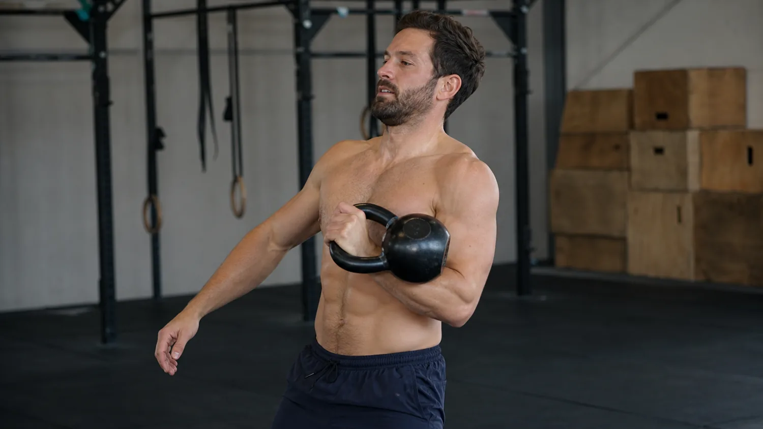 CrossFit athlete keeping a kettlebell close during the clean pull