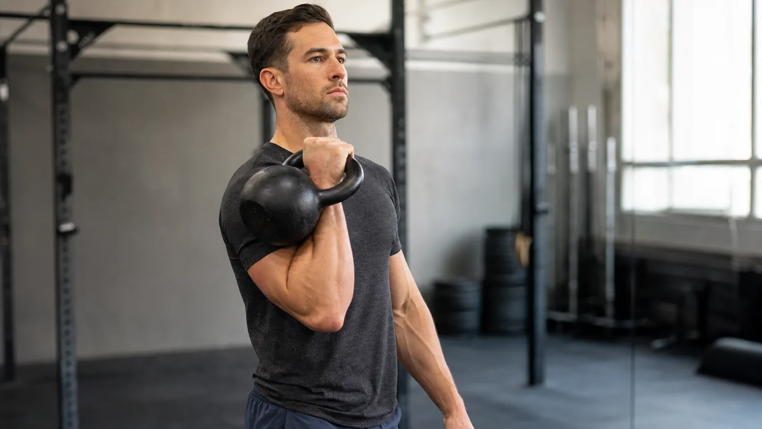 CrossFit athlete catching a kettlebell clean in a quiet rack position