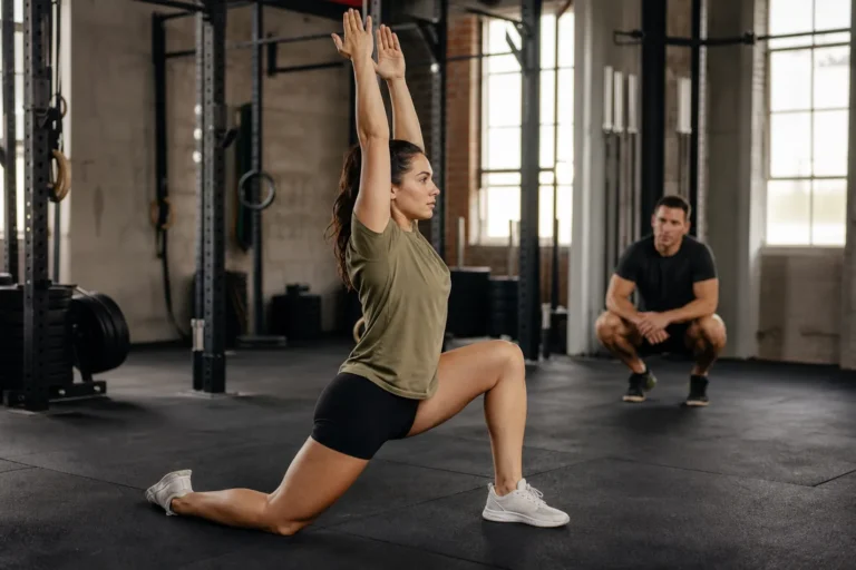 CrossFit athlete performing a Samson stretch lunge during warm-up